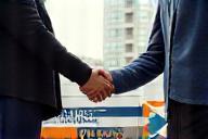 Kihe Touch vehicle and local business handshake, symbolizing trust