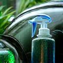 Eco-friendly cleansers and water-saving tools at work on a vehicle