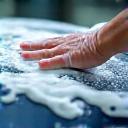 Hand washing a sedan at Kihe Touch, soap and bubbles